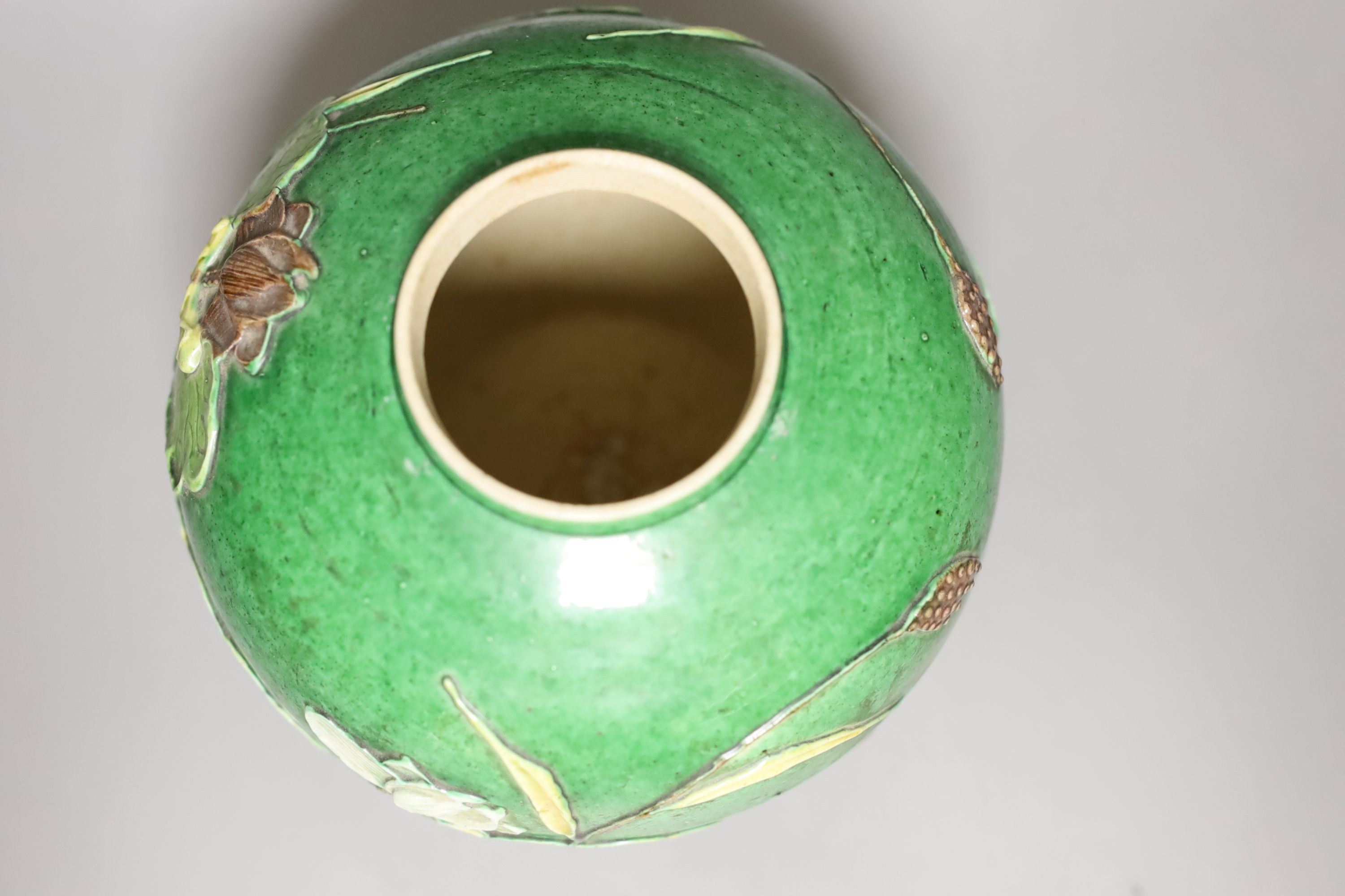 An early 20th century Chinese green-glazed ‘lotus’ jar and cover 18cm